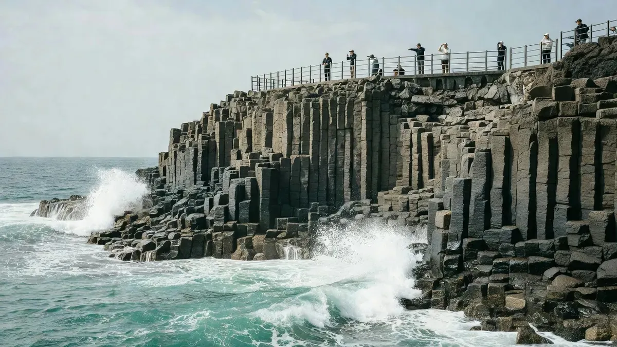 Hexagonal Jusangjeolli basalt cliffs meeting turquoise waves on a west-coast tour of Jeju Island Korea, South Korea